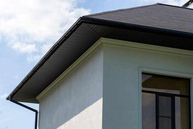 Close up of plastic soffit fascia board and roof gutters